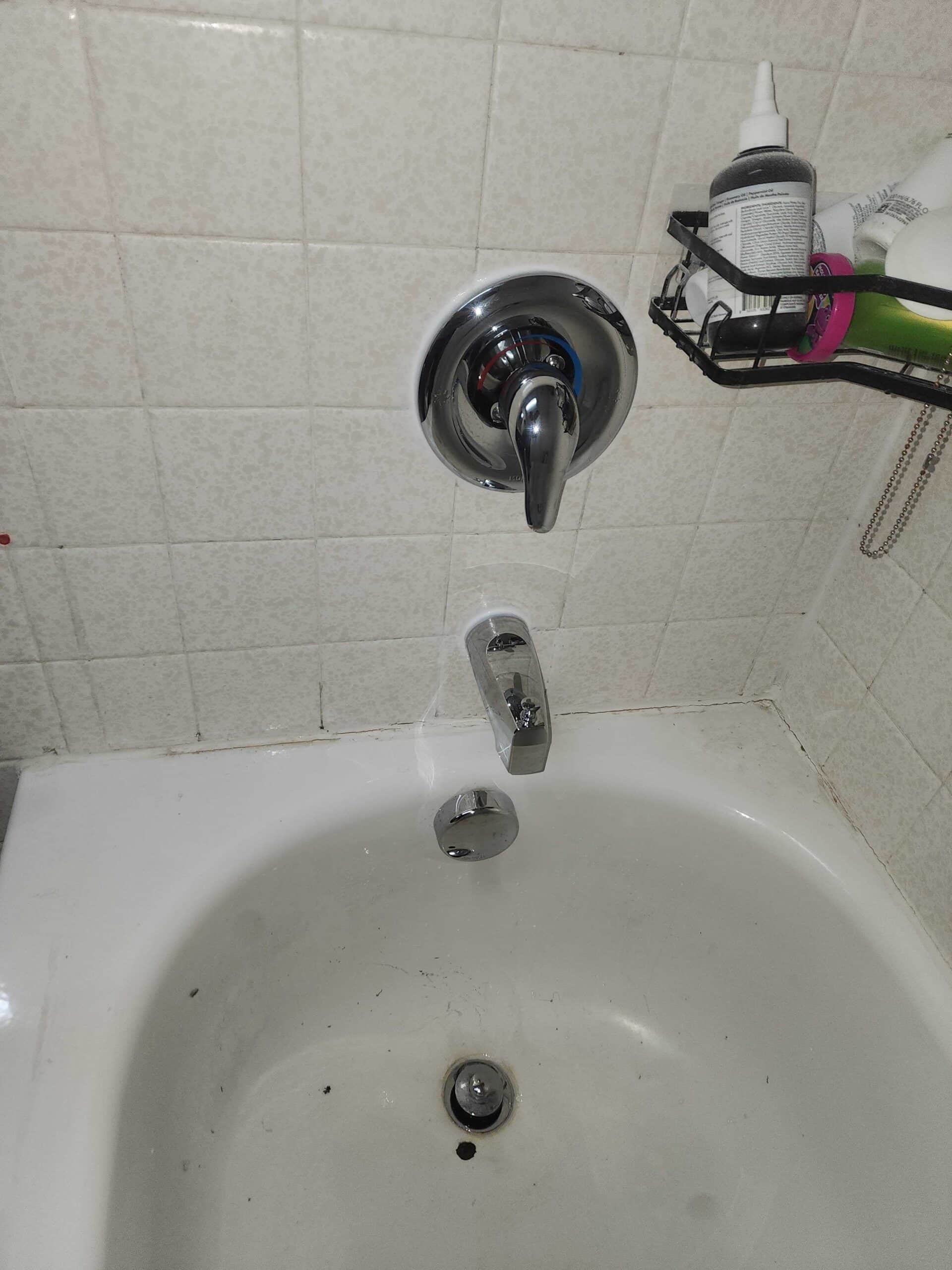 Close-up of repaired bathtub faucet and shower control