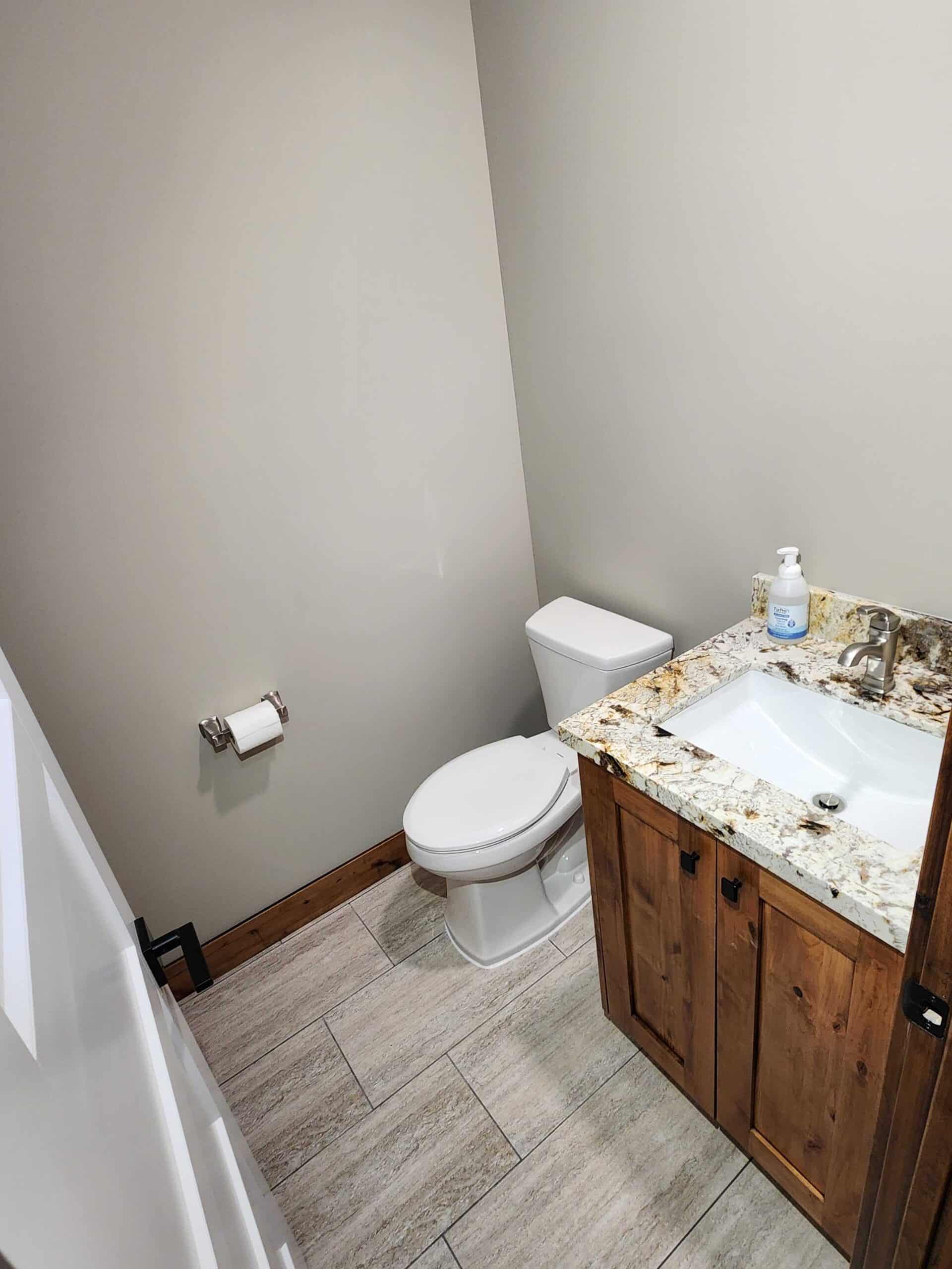 Bathroom with toilet, vanity, and plumbing improvements