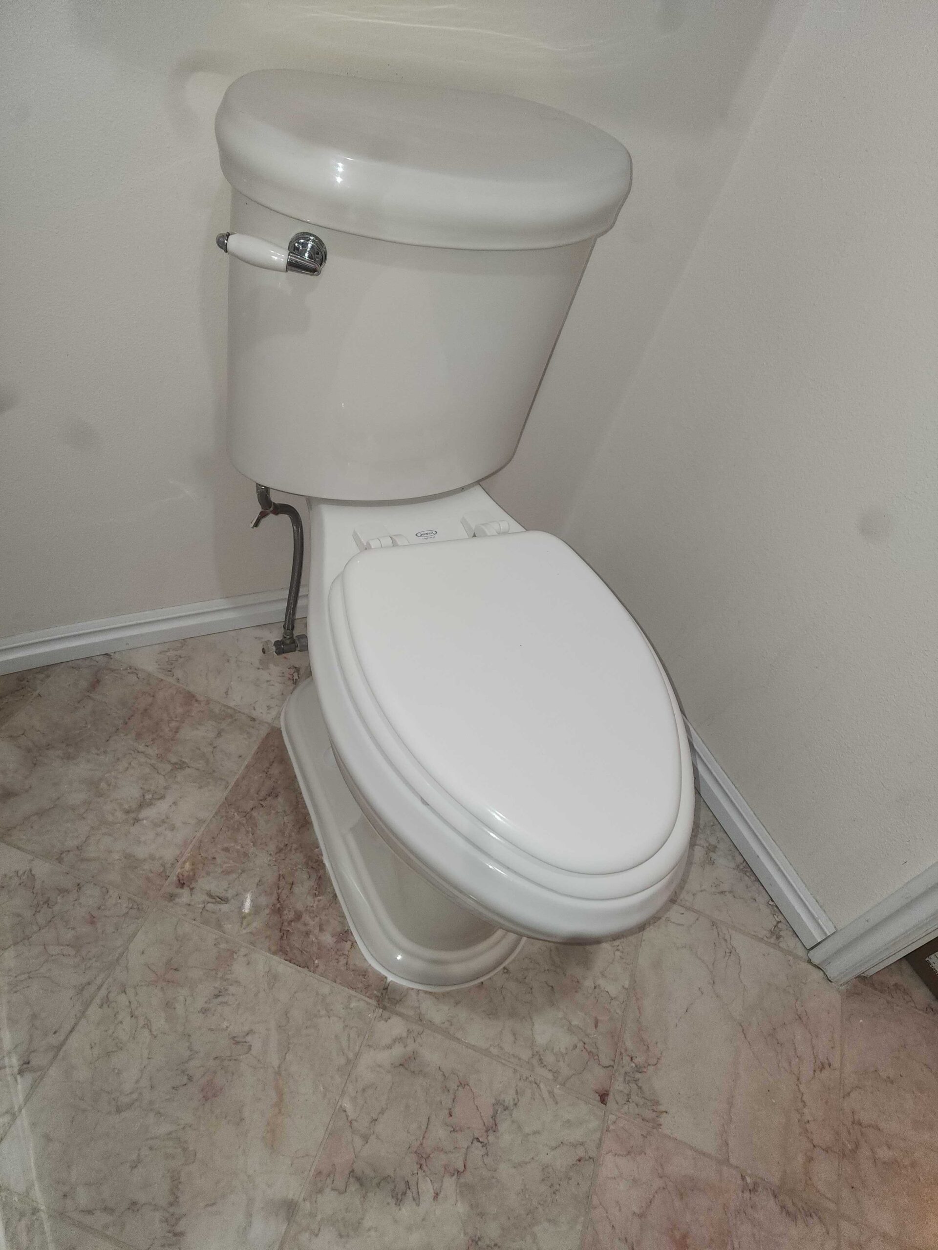 White toilet installed on luxury vinyl flooring