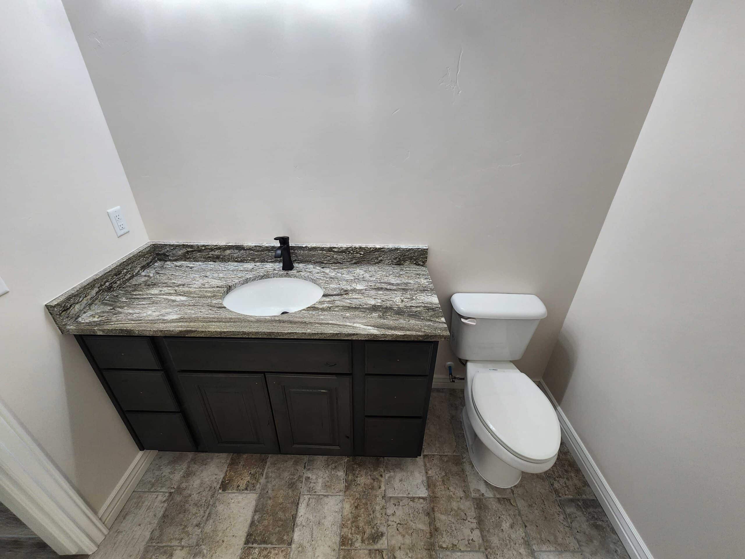 Granite vanity and toilet after plumbing installation